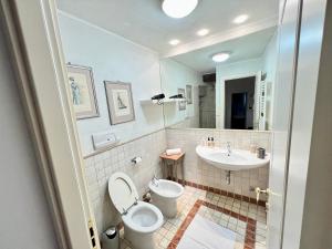 a bathroom with a toilet and a sink at [Art of Bergamo] Luxury & design house in Bergamo