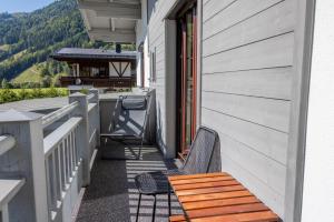 a balcony with a wooden bench on a house at Haus Trudi in Walchsee