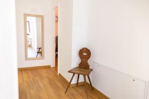 a chair in a room with a mirror at Haus Trudi in Walchsee