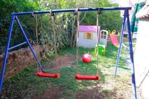 a swing set in a yard with an apple on it at Apartments with a parking space Orebic, Peljesac - 14834 in Orebić
