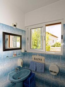a bathroom with a sink and two windows at Apartments with a parking space Orebic, Peljesac - 14834 in Orebić