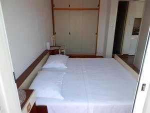 a bedroom with a large bed with white sheets at Apartments by the sea Loviste, Peljesac - 15150 in Lovište