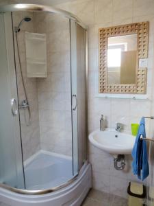 a bathroom with a shower and a sink at Apartments by the sea Veli Rat, Dugi otok - 15006 in Veli Rat