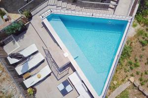 an overhead view of a large swimming pool at Family friendly house with a swimming pool Slatine, Ciovo - 15149 in Slatine