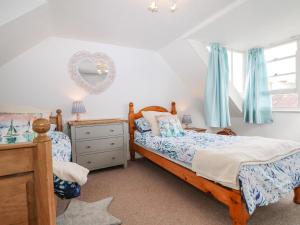 a bedroom with two beds and a mirror on the wall at High Tide in Herne Bay