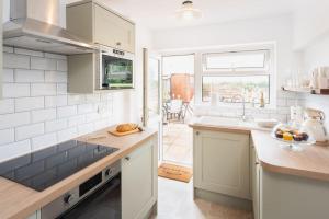 a kitchen with a sink and a counter top at *Brand New* Olive Grove Cottage in Torquay