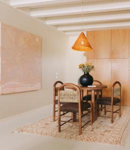 a dining room with a table and chairs and a lamp at Village Aparthotel By BOA in Porto