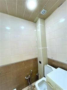 a bathroom with a toilet and a sink at M Estate. 2 Room Home in Targovu in Baku