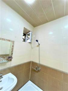 a bathroom with a sink and a toilet and a mirror at M Estate. 2 Room Home in Targovu in Baku