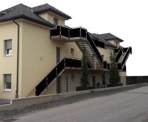 a building with stairs on the side of it at Sorinas Home - Comfortable Apartment near Graz - Free Parking in Wagersbach
