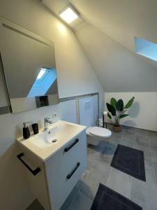 a bathroom with a sink and a toilet and a mirror at Sorinas Unterkunft WB16 Top 15 