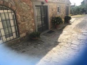 a building with a gate and potted plants in front of it at Agriturismo I Poggi in Impruneta