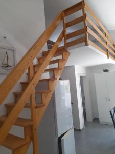 escalera de madera en una habitación con nevera en Apartments Jelancic, en Pag