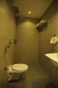 a bathroom with a toilet and a sink at Hotel City Express Udaipur - My Downtown Hotels in Udaipur +27 photos