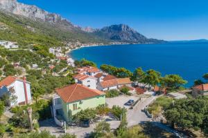 an aerial view of a village on a hill with the ocean at Apartments by the sea Podaca, Makarska - 9712 in Podaca