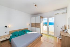 a bedroom with a bed and a view of the ocean at Apartments by the sea Podaca, Makarska - 9712 in Podaca