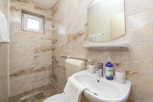 a bathroom with a sink and a toilet and a mirror at Apartments by the sea Podaca, Makarska - 9712 in Podaca