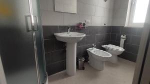 a bathroom with a sink and a toilet at Agriturismo Il Borgo in Passo di Mirabella