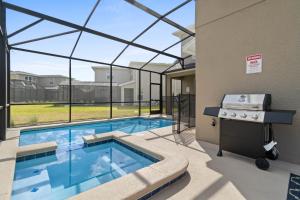 a swimming pool with a view of a building at Beautiful Family Villa - Pool and Hot Tub - Near Disney World in Kissimmee