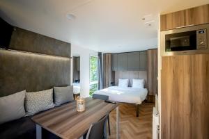 a room with a bed and a table in a room at Urban Gardens Gent in Ghent +130 photos