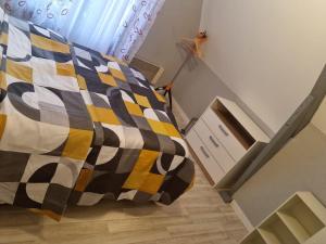 sypialnia z łóżkiem z kocem szachowym w obiekcie Belle chambre avec balcon w mieście Arques