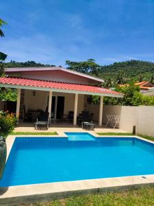 a swimming pool in front of a house at Wirason villa 2BR in Koh Samui