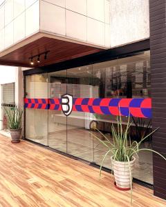 a store front with a red and blue ribbon at Dublê Hotel - The Original in Recife