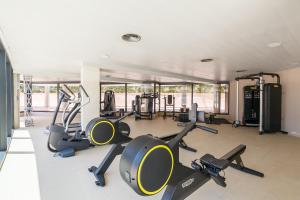 a gym with several treadmills and cardio machines at UHC SOL CAMBRILS PARK in Cambrils +38 photos