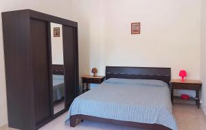 a bedroom with a bed and a large mirror at B&B Il Cortile del Sole in Olmedo