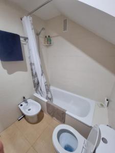 a bathroom with a white toilet and a sink at Condado De Alhama Golf Resort 2 Bedroom Apartment Jardine 13 in Murcia