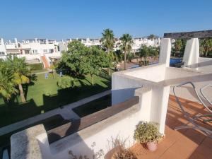 a balcony with a view of a park and buildings at Condado De Alhama Golf Resort 2 Bedroom Apartment Jardine 13 in Murcia