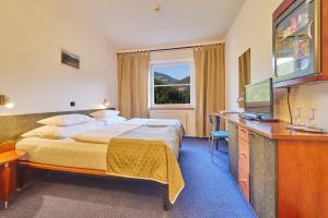Postel nebo postele na pokoji v ubytování Hotel Horizont
