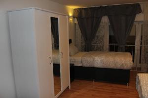 
a bedroom with a bed and a dresser at Hotel Garni Emir in Cologne
