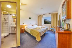 Postel nebo postele na pokoji v ubytování Hotel Horizont