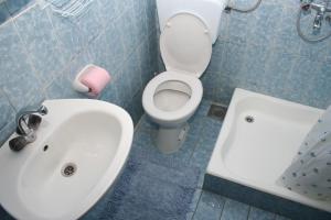 a bathroom with a white sink and a toilet at Apartments and rooms with parking space Bol, Brac - 2878 in Bol