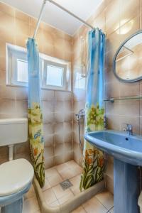 a bathroom with a shower and a sink and a toilet at Apartments by the sea Sumartin, Brac - 2952 in Sumartin