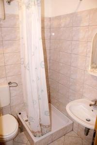 a bathroom with a shower and a toilet and a sink at Apartments and rooms with parking space Bol, Brac - 2926 in Bol