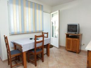 a dining room with a table and a television at Apartments and rooms with WiFi Vrsar, Porec - 3007 in Vrsar