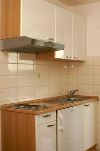 a kitchen with a sink and a stove at Studio Duce 2821a in Duće