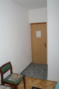 a room with a door and a chair and a table at Double Room Sutivan 2943b in Sutivan