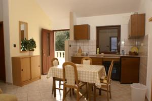 a kitchen and dining room with a table and chairs at Apartments with a swimming pool Splitska, Brac - 2889 in Splitska