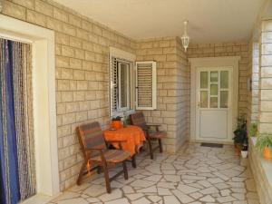 a patio with a table and chairs and a door at Apartment Mirca 2838b in Mirce