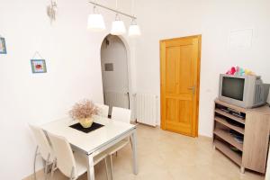 a dining room with a table and a tv at Apartments with a parking space Bol, Brac - 2900 in Bol