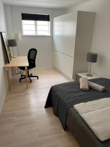 a bedroom with a bed and a desk and a table at CPH Lux Apartments KH in Copenhagen