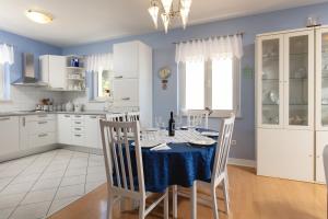 a kitchen with a table with a blue table cloth at Apartments by the sea Sumartin, Brac - 2940 in Sumartin