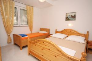 a bedroom with two beds and a window at Apartments with parking space Vodice - 2995 in Vodice
