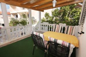 a porch with a yellow table and chairs on it at Apartments with parking space Vodice - 2995 in Vodice +59 photos