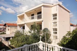 a white building with a white fence in front of it at Apartments with parking space Vodice - 2995 in Vodice
