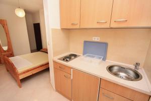 a small kitchen with a sink and a bed at Apartments with parking space Vodice - 2995 in Vodice