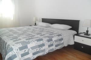 a bedroom with a bed with two pillows on it at Apartments by the sea Splitska, Brac - 2923 in Postira